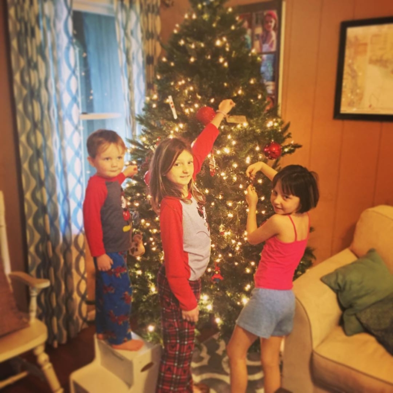 Trimming the tree with my big kids. #christmastimeishere #myohmia #whatalittlejewel #liljoman